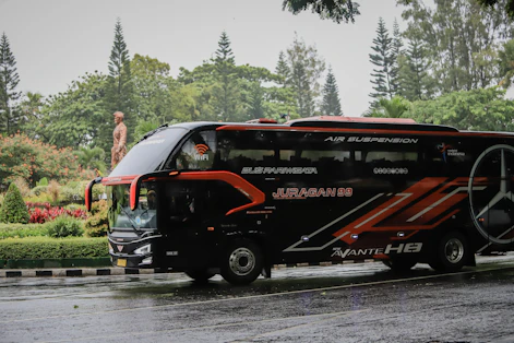 a black bus on a road