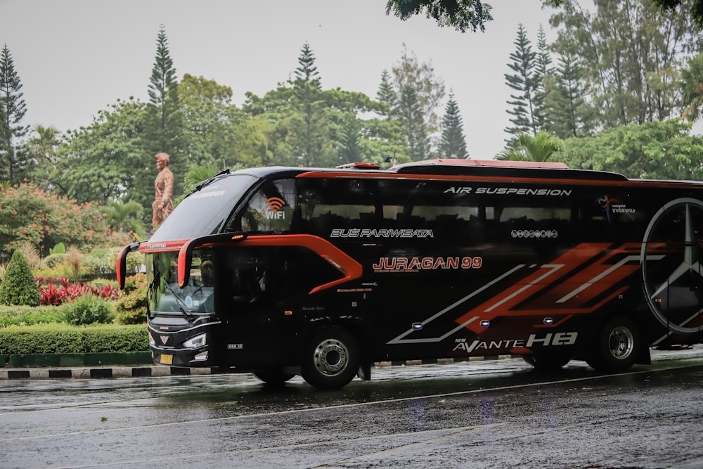 a black bus on a road