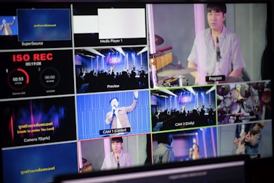 A multi-screen display showing various camera angles and views of a music or worship event. The screens include a live audience, performers on a stage, close-ups of a drummer, and a person speaking or singing. There are also overlay texts with labels such as 'ISO REC', 'Preview', and different camera numbers.