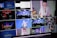 A multi-screen display showing various camera angles and views of a music or worship event. The screens include a live audience, performers on a stage, close-ups of a drummer, and a person speaking or singing. There are also overlay texts with labels such as 'ISO REC', 'Preview', and different camera numbers.