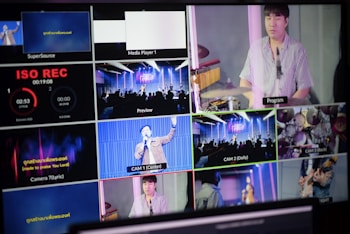 A multi-screen display showing various camera angles and views of a music or worship event. The screens include a live audience, performers on a stage, close-ups of a drummer, and a person speaking or singing. There are also overlay texts with labels such as 'ISO REC', 'Preview', and different camera numbers.
