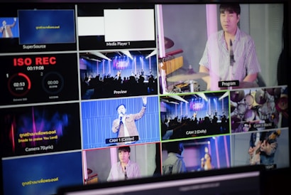 A multi-screen display showing various camera angles and views of a music or worship event. The screens include a live audience, performers on a stage, close-ups of a drummer, and a person speaking or singing. There are also overlay texts with labels such as 'ISO REC', 'Preview', and different camera numbers.