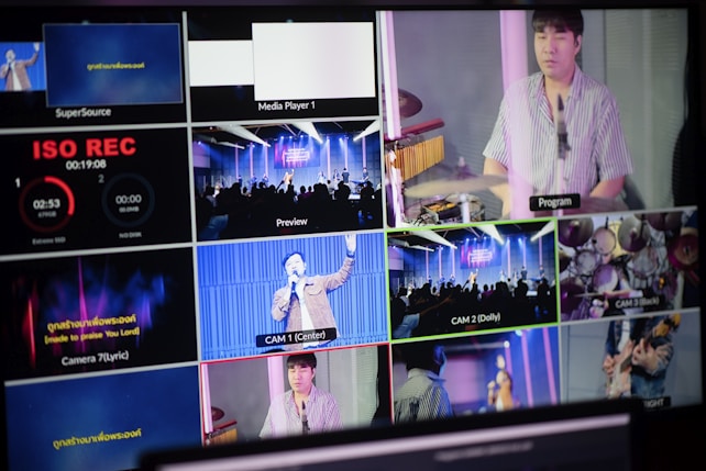 A multi-screen display showing various camera angles and views of a music or worship event. The screens include a live audience, performers on a stage, close-ups of a drummer, and a person speaking or singing. There are also overlay texts with labels such as 'ISO REC', 'Preview', and different camera numbers.