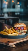 A colorful burger platter shaped like a dinosaur footprint on a rustic wooden table.