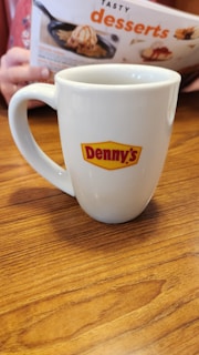 Staff members at Denny's happily serving customers.