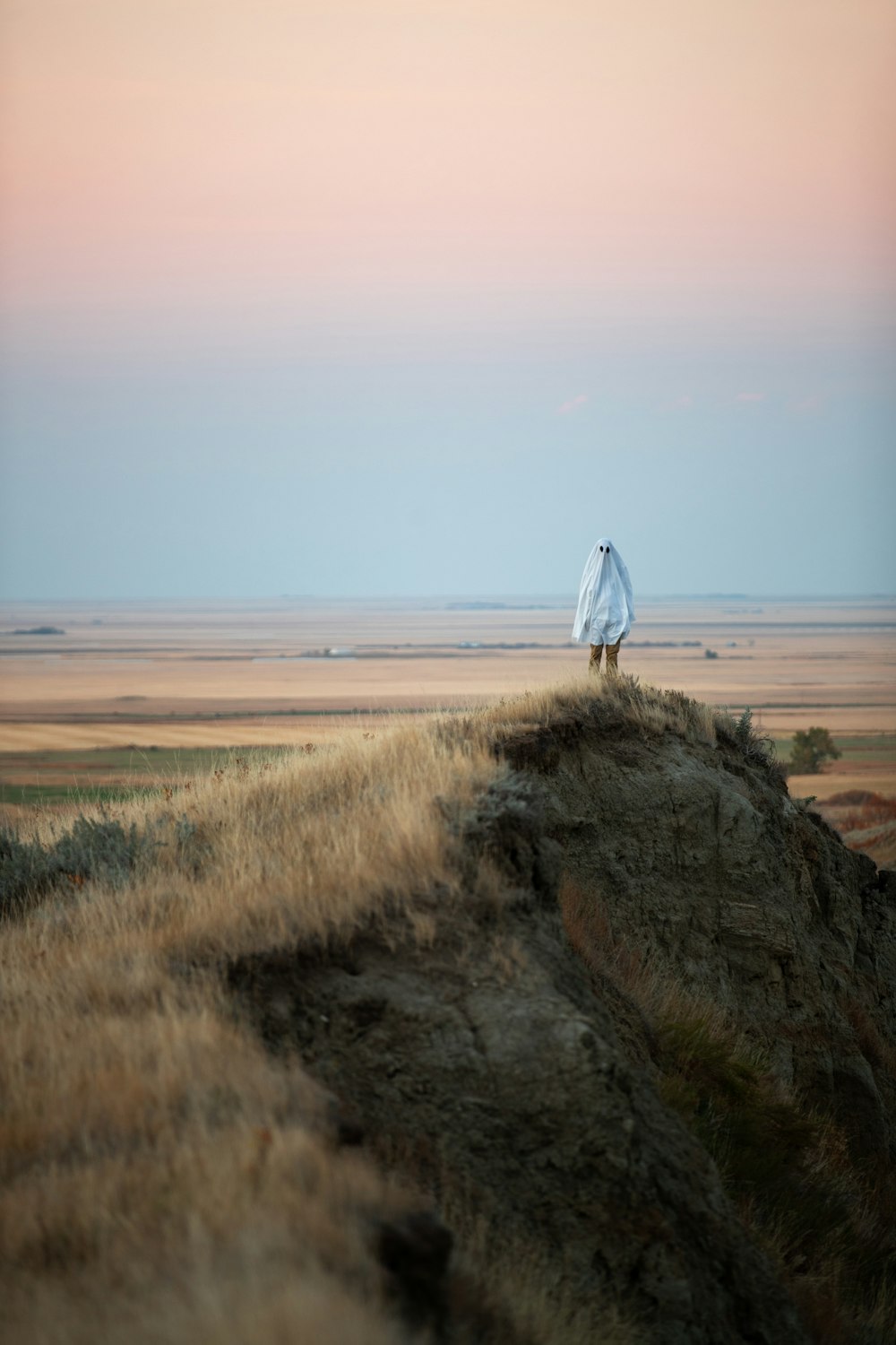 a person holding an umbrella on a beach