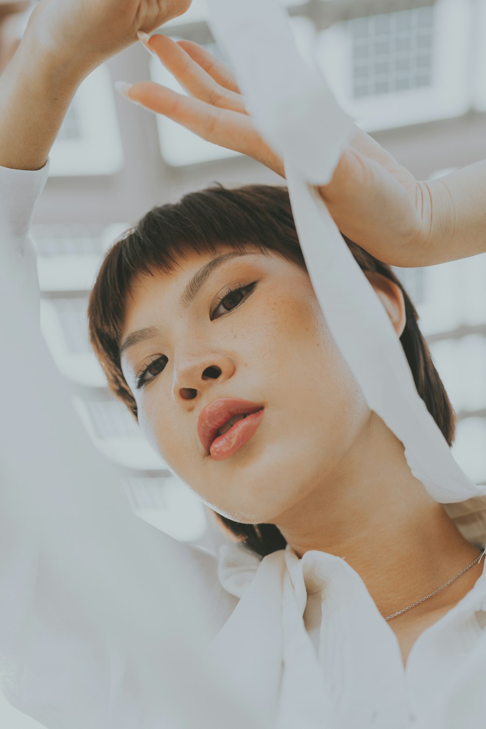 a woman with her hands on her head