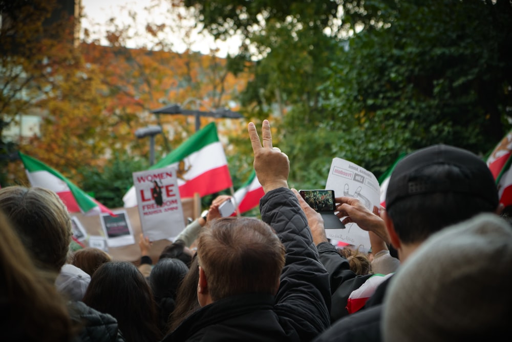 a group of people holding signs and flags