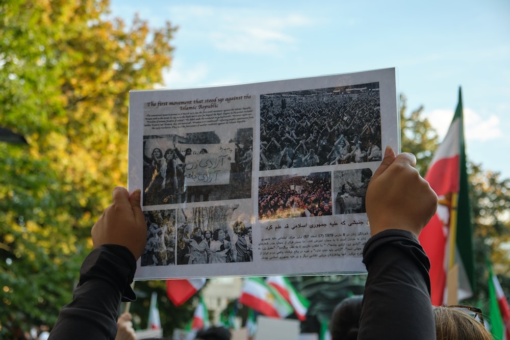 a group of people holding up a poster