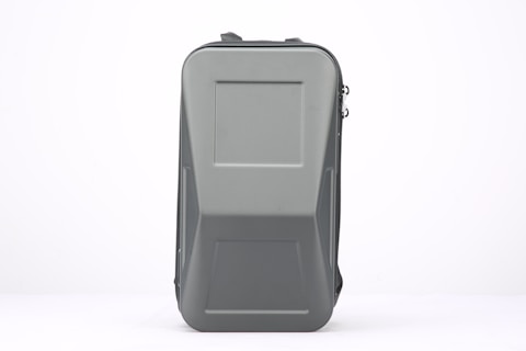 A rectangular, hard-shell case with a smooth gray surface. The case has a robust and sturdy design with a zipper running down its side and a handle on top for easy carrying.