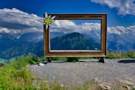 a sign with a mountain in the background
