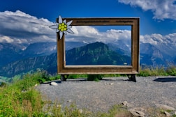 a sign with a mountain in the background