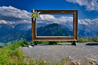 a sign with a mountain in the background