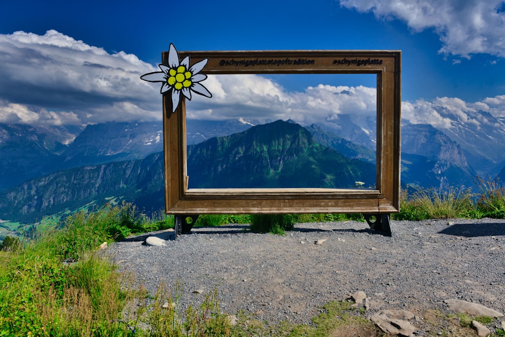 a sign with a mountain in the background