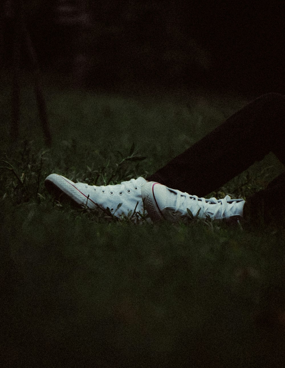 a person's shoe on grass