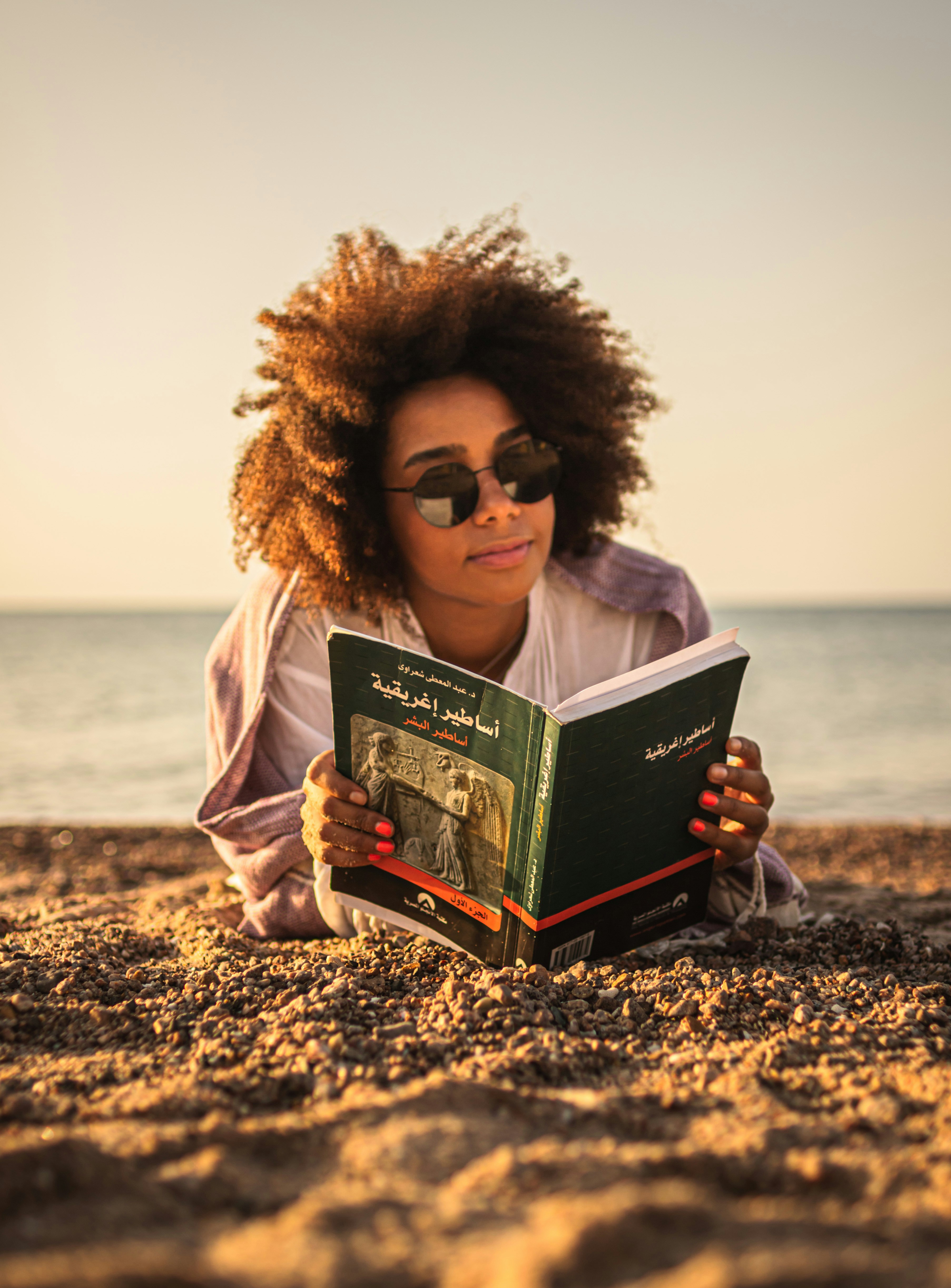 Egyptian girl reading on the beach