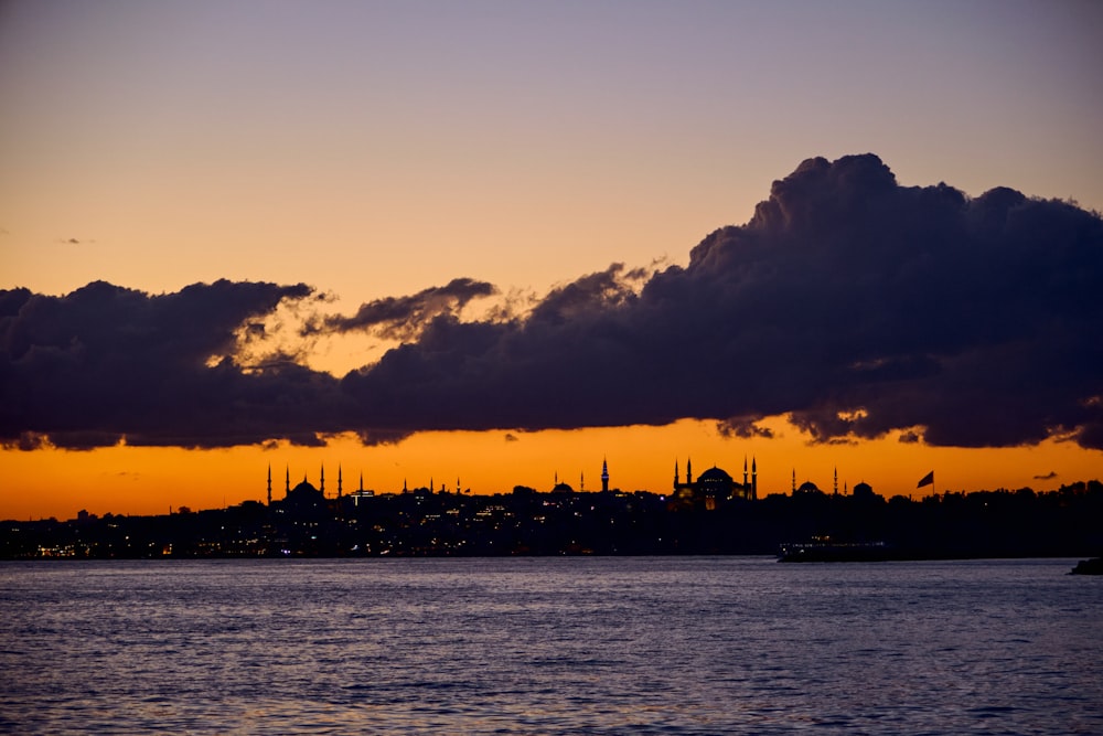 a body of water with a city in the distance