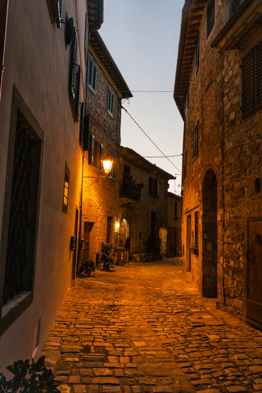 a cobblestone street between buildings