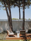 a deck with chairs and trees