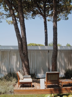 a deck with chairs and trees
