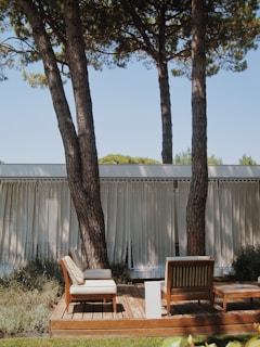 a deck with chairs and trees