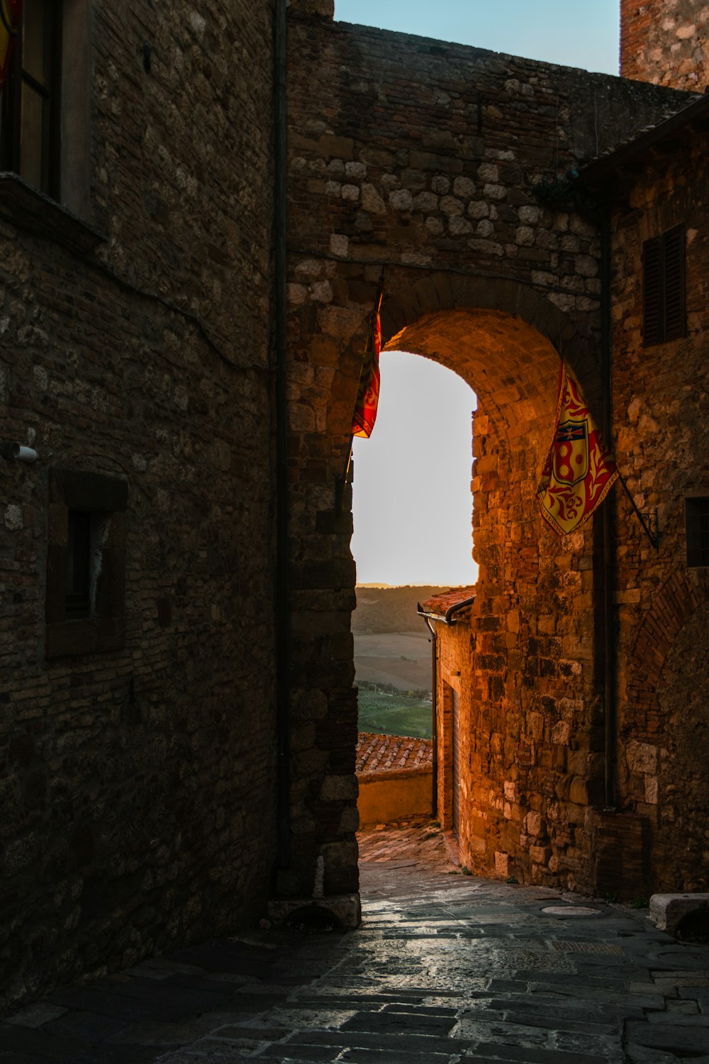 a stone archway with a flag