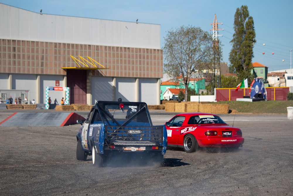 a couple of race cars parked in front of a building