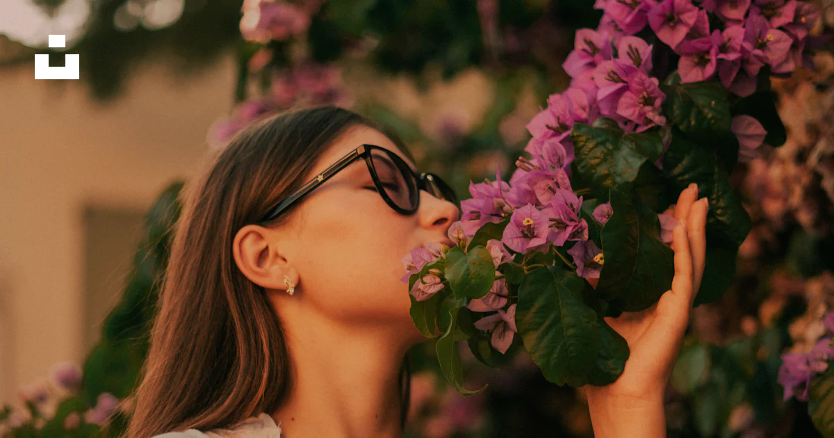 A woman smelling a flower photo – Free Italy Image on Unsplash