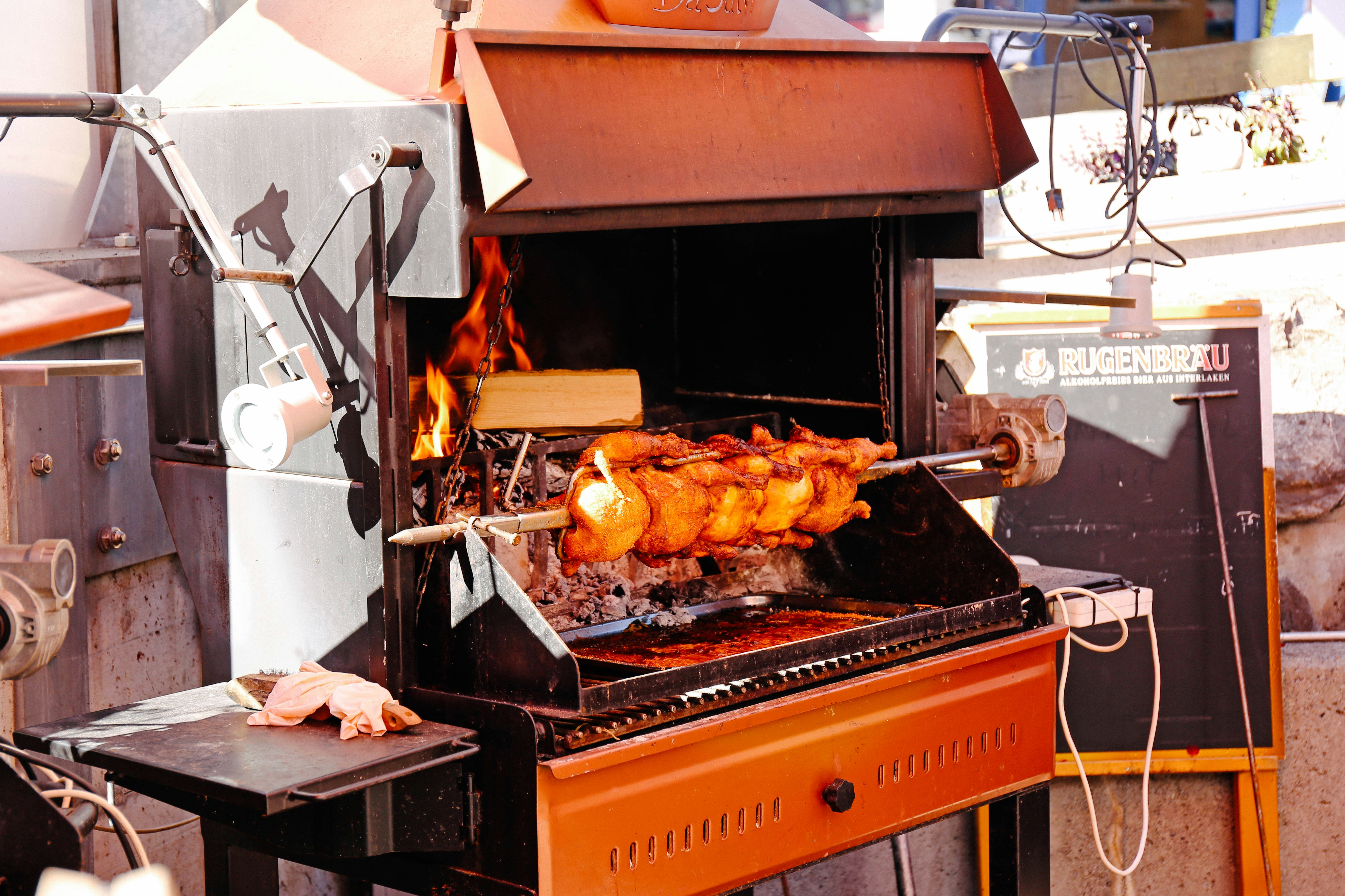 a large grill with meat cooking on it