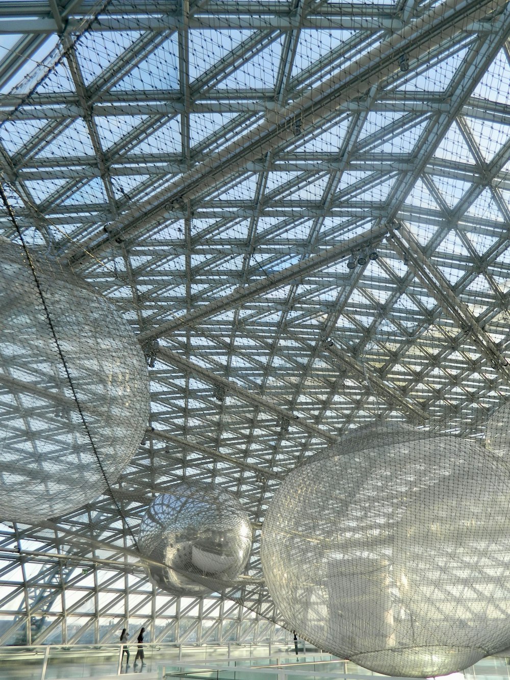 a large glass ceiling with people walking around