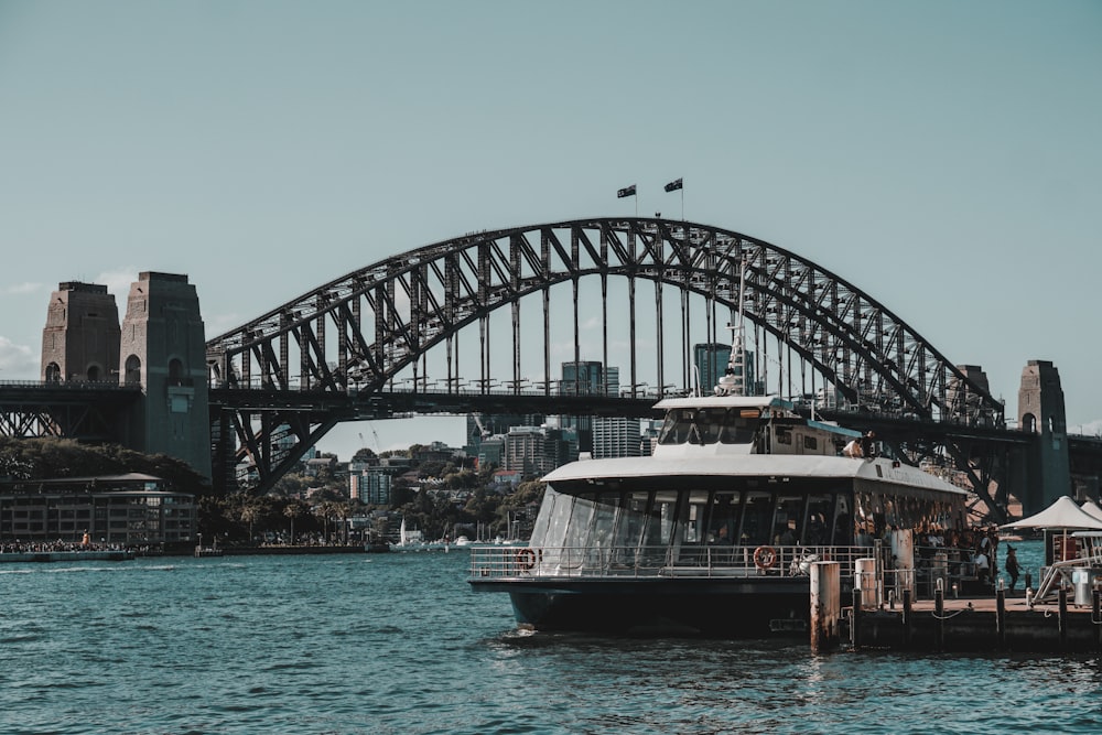 a boat in the water with Sydney Harbour Bridge in the background