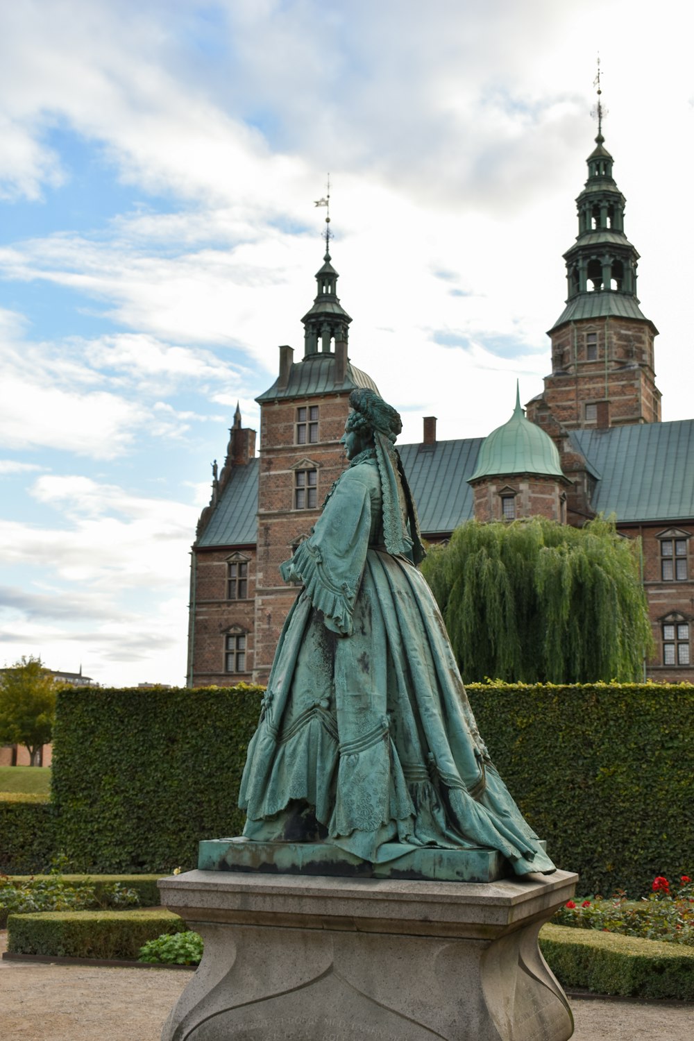 a statue in front of Rosenborg Castle
