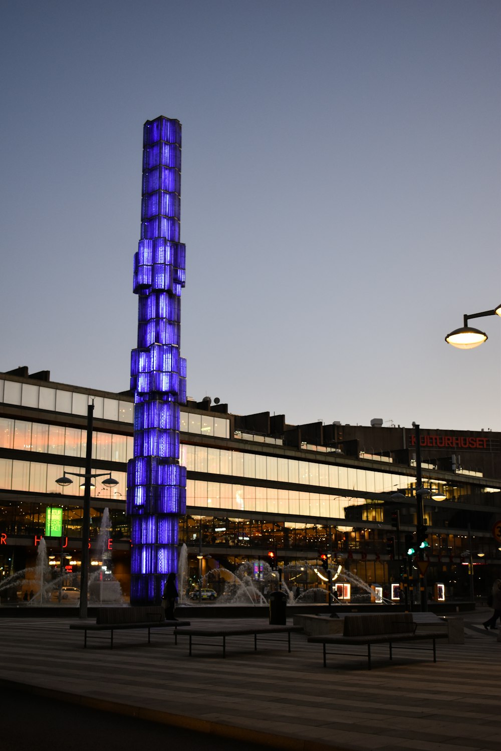 a tall building with a blue and purple tower