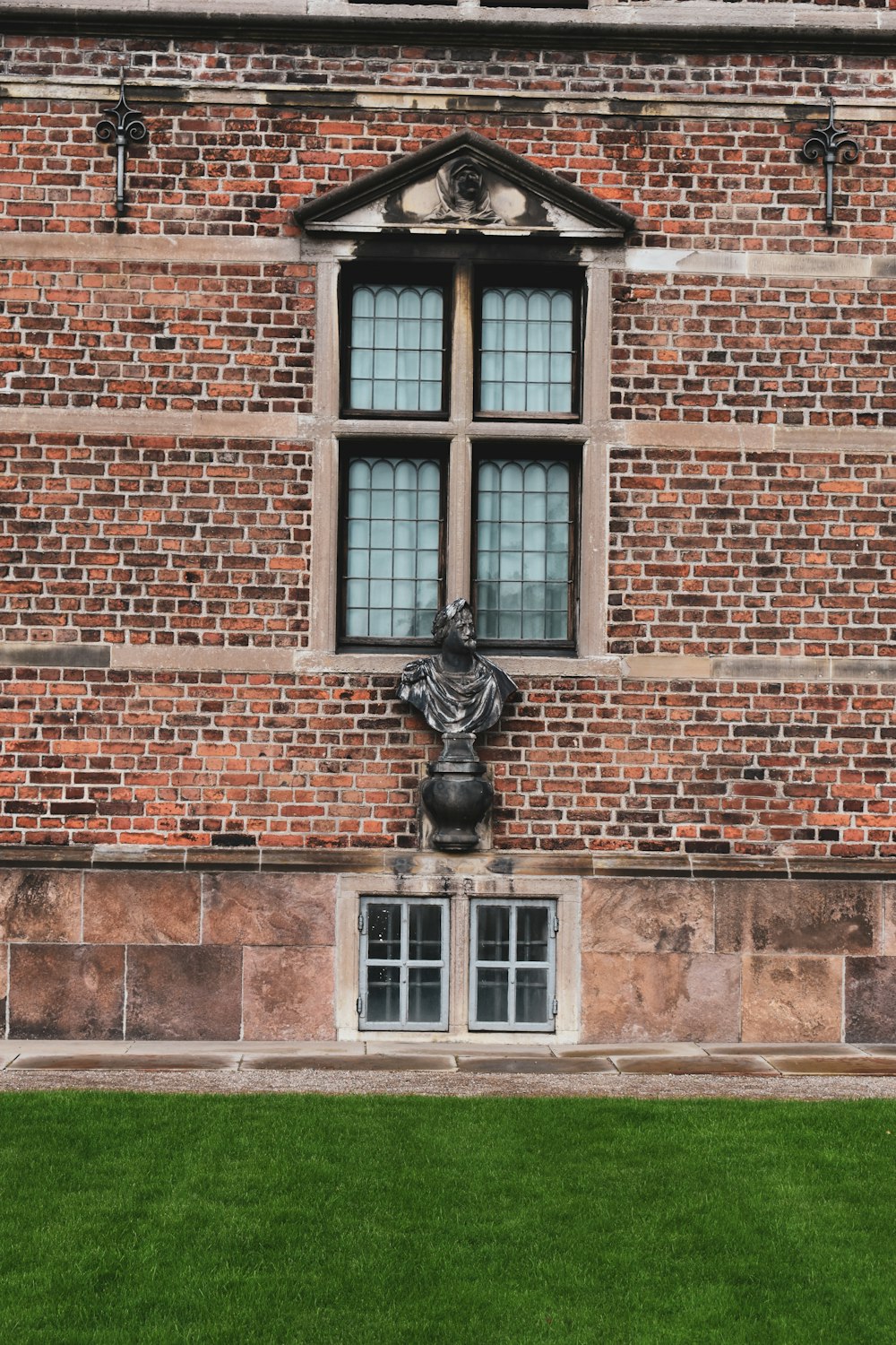 a statue in front of a brick building