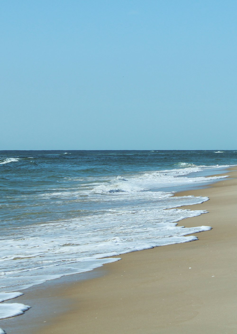 a beach with waves crashing on it