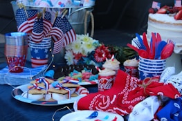 A festive tailgate event with red, white, and blue decorations and smiling attendees.