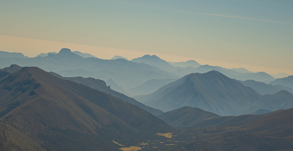 a landscape with hills and a blue sky