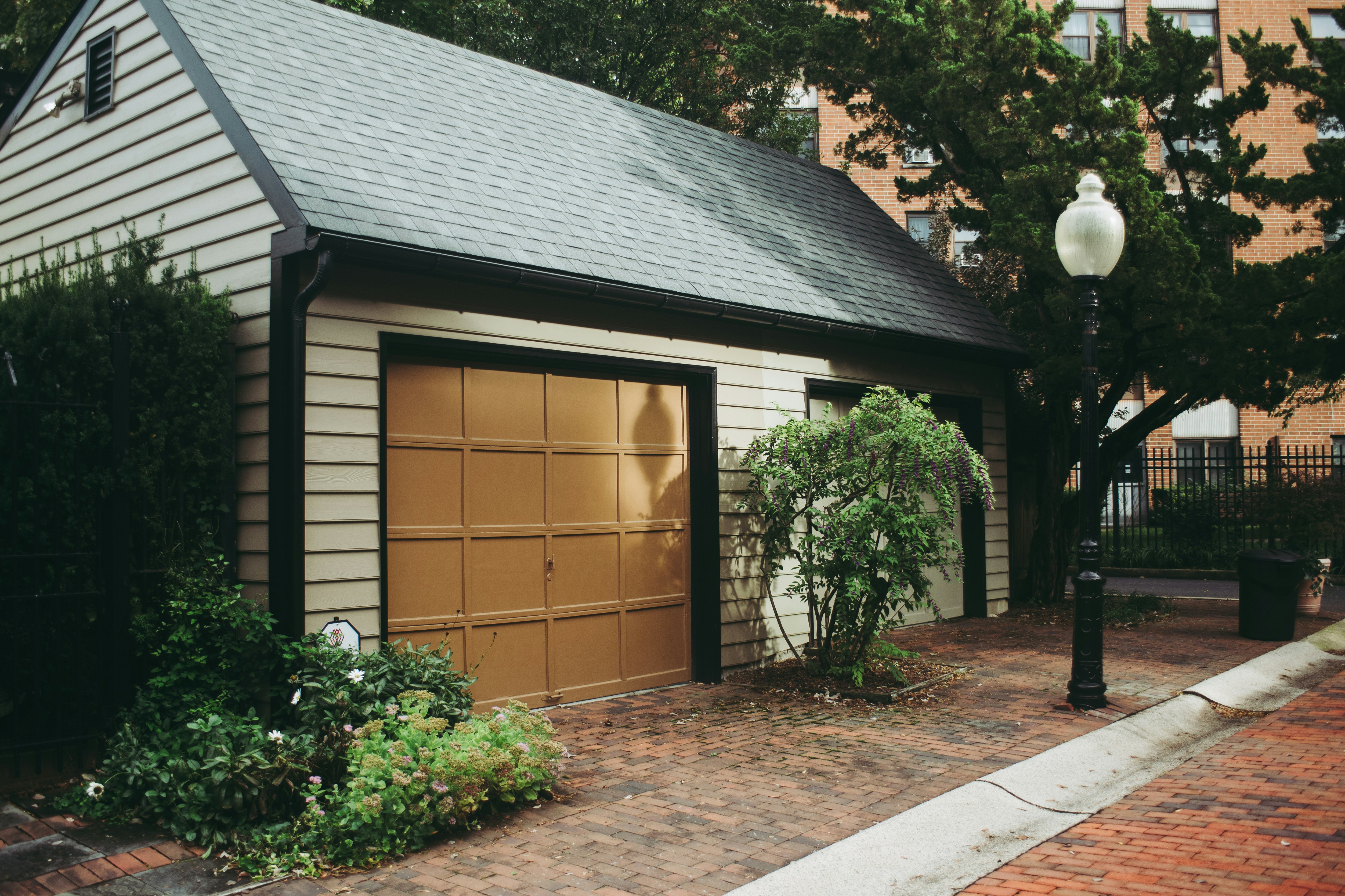 a stunning carriage house style garage door enhancing a suburban home - how a new garage door increases home value