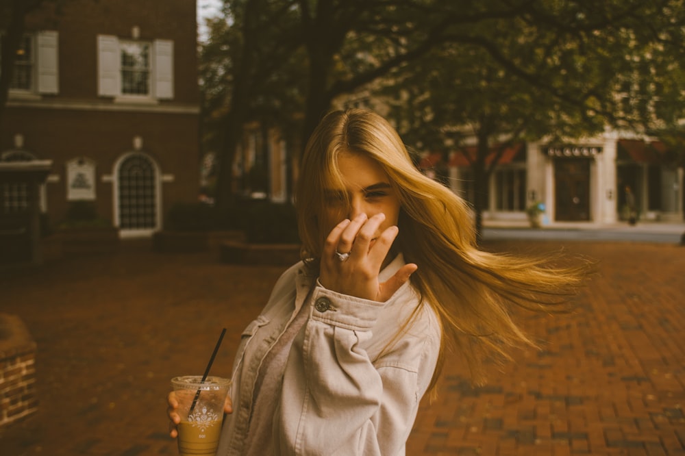 a woman holding a drink