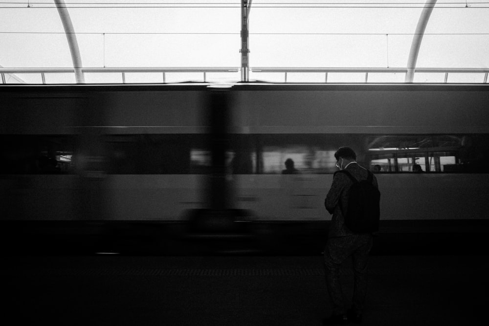 a person standing next to a train