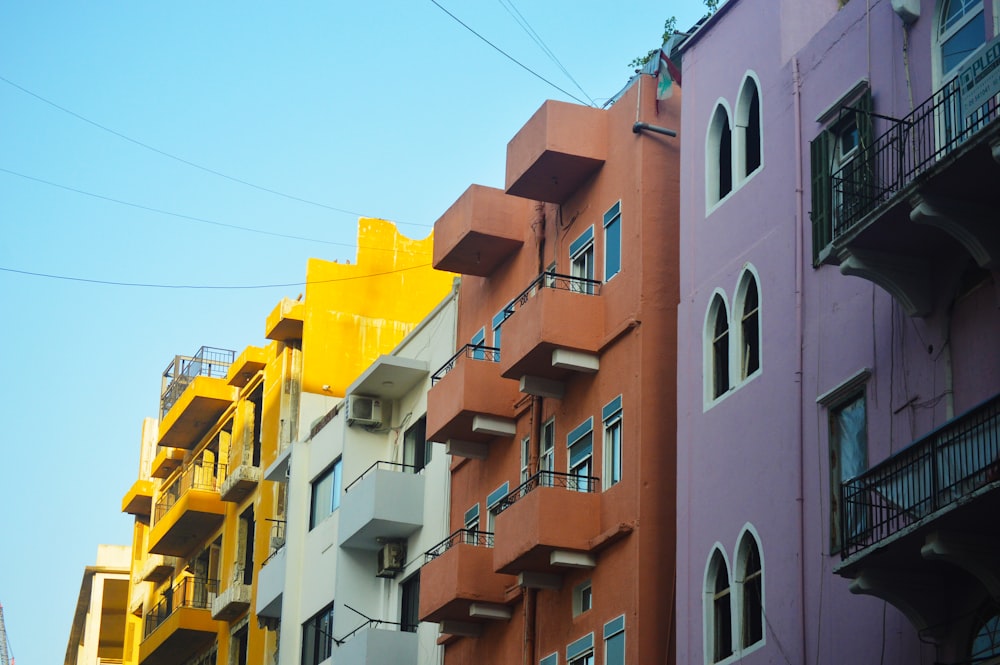 a row of buildings with balconies and a blue sky