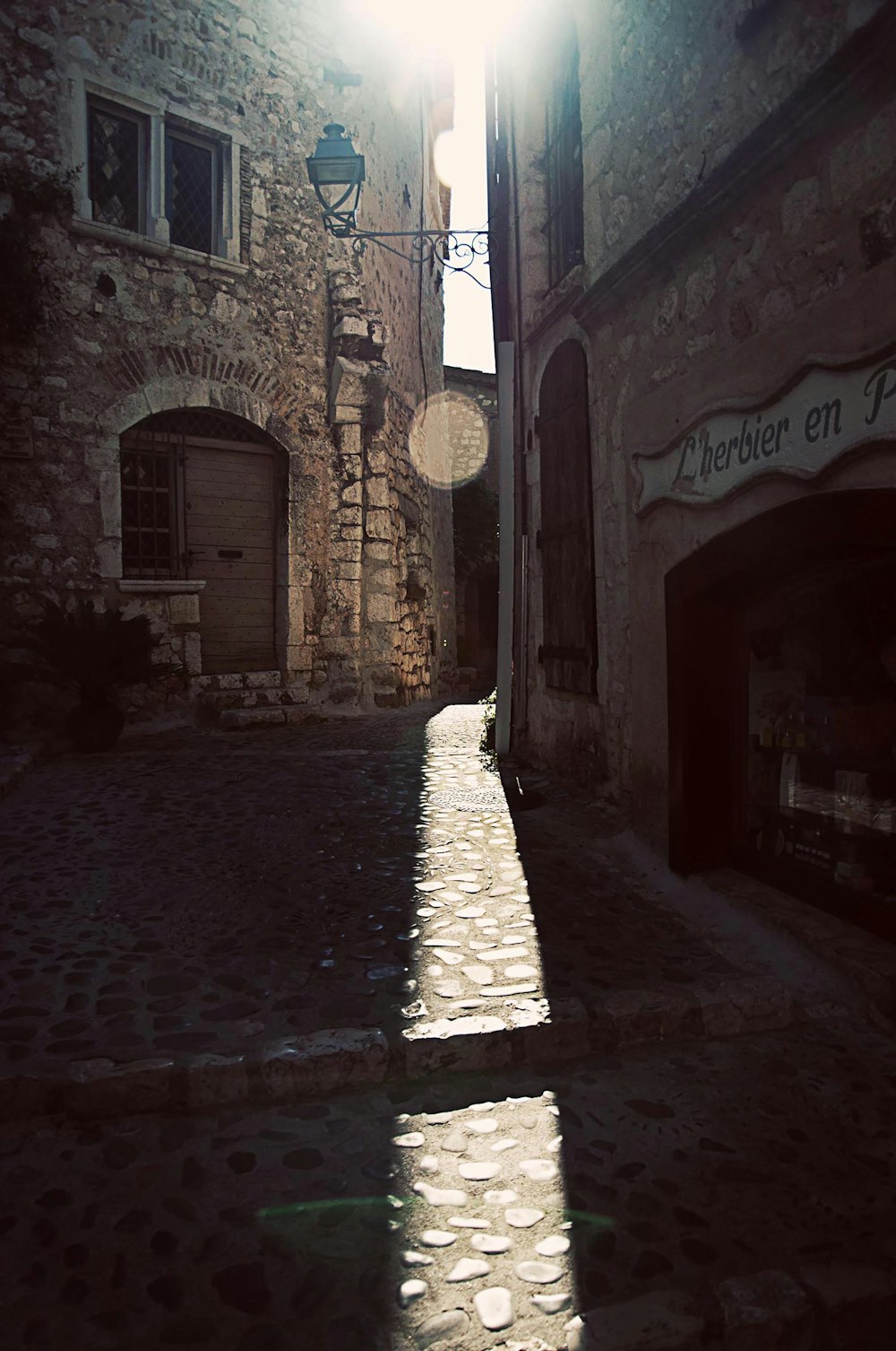 a cobblestone street with buildings on either side of it