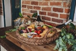 A festive basket combining fruits, cheeses, and charcuterie for a special event.