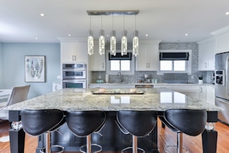a kitchen with a marble island