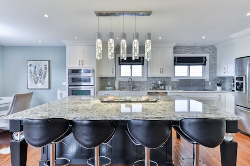 a kitchen with a marble island