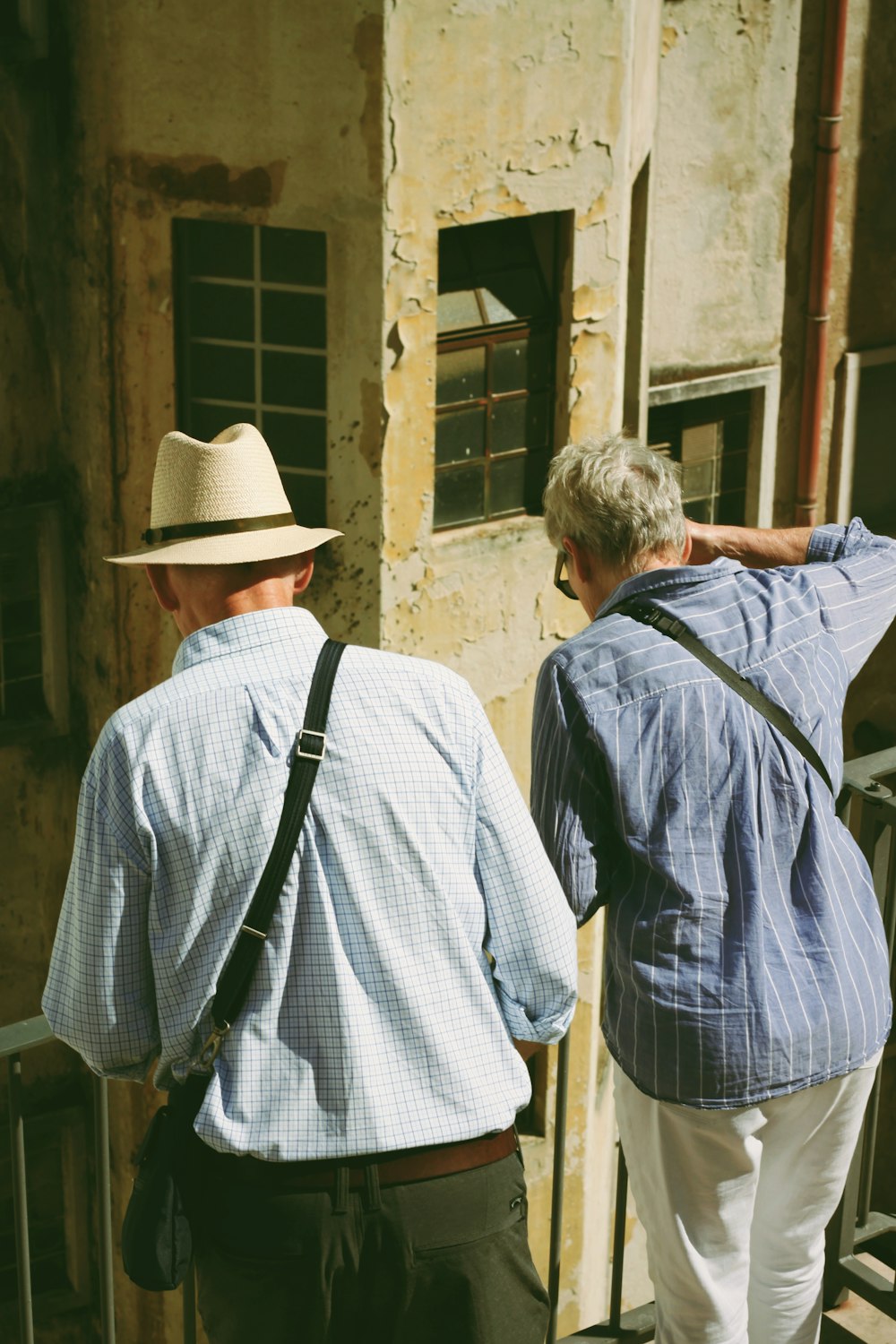 a couple of men looking at a building