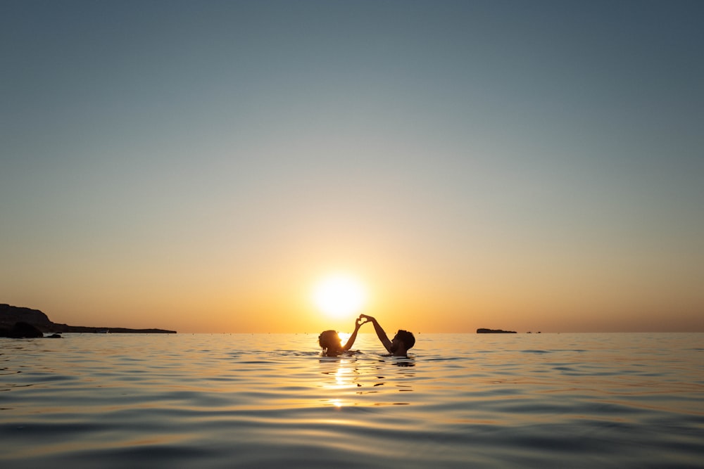 a couple people in the water