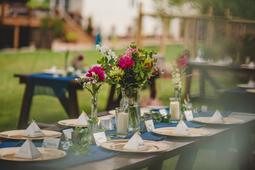 a table with flowers and candles