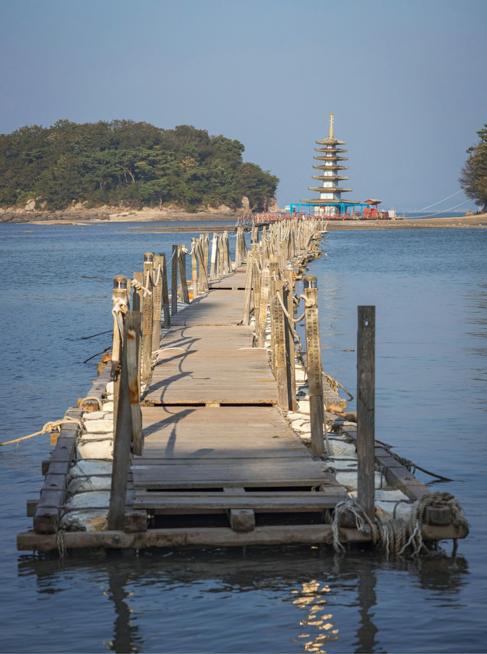 a dock with a tower in the background