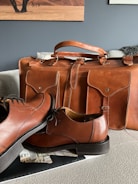 A row of briefcases in classic, minimalist, and multi-functional styles displayed on a wooden shelf.